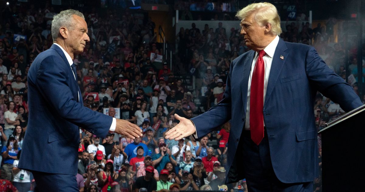 Former independent presidential candidate Robert Kennedy Jr., left, joins former President Donald Trump, right, during a campaign rally in Glendale, Arizona, on Friday.