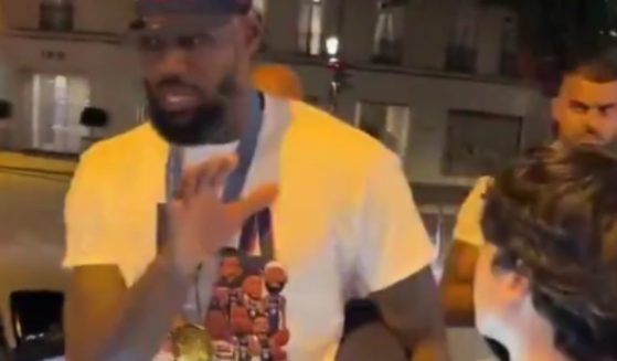 LeBron James, left, was seen on video telling a young fan, right, to back off after he was asked to take a photo in Paris, France.