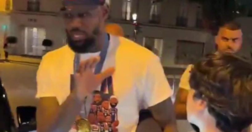 LeBron James, left, was seen on video telling a young fan, right, to back off after he was asked to take a photo in Paris, France.