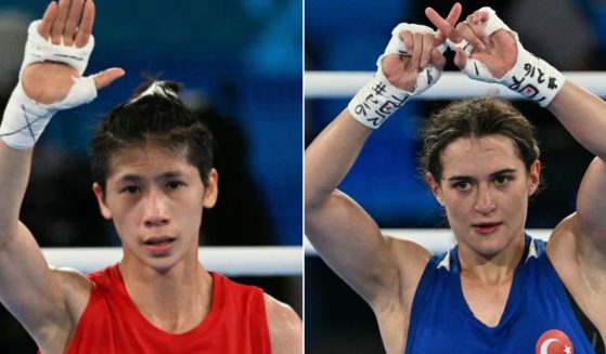 Turkey's Esra Yildiz Kahraman, right, in blue, reacts after losing to Taiwan's Lin Yu-ting, left, in the women's 57kg semi-final boxing match during the Paris 2024 Olympic Games Wednesday.