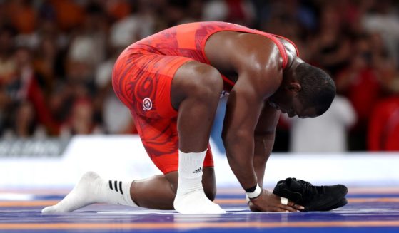 Mijain Lopez Nunez of Team Cuba removes his shoes to signify his retirement following his victory and earning of fifth Olympic Gold during the Wrestling Men's Greco-roman 130kg Gold Medal match against Yasmani Acosta Fernandez of Team Chile on day 11 of the 2024 Olympic Games Tuesday in Paris