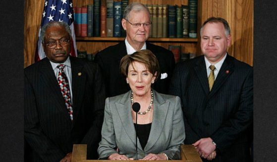 Democrat House Speaker Nancy Pelosi, center, thanked then-Minnesota Rep.Tim Walz, right, for his service on the battlefield during a news conference on Capitol Hill in February of 2007 in Washington, D.C.