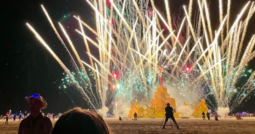 A security guard keeps people back during the annual Burning Man Festival on September 4, 2023. Thousands of revelers stuck in the mud for days at the Burning Man festival in the US state of Nevada were told they could finally trek home on September 4, 2023, after torrential rain had prompted shelter-in-place orders.