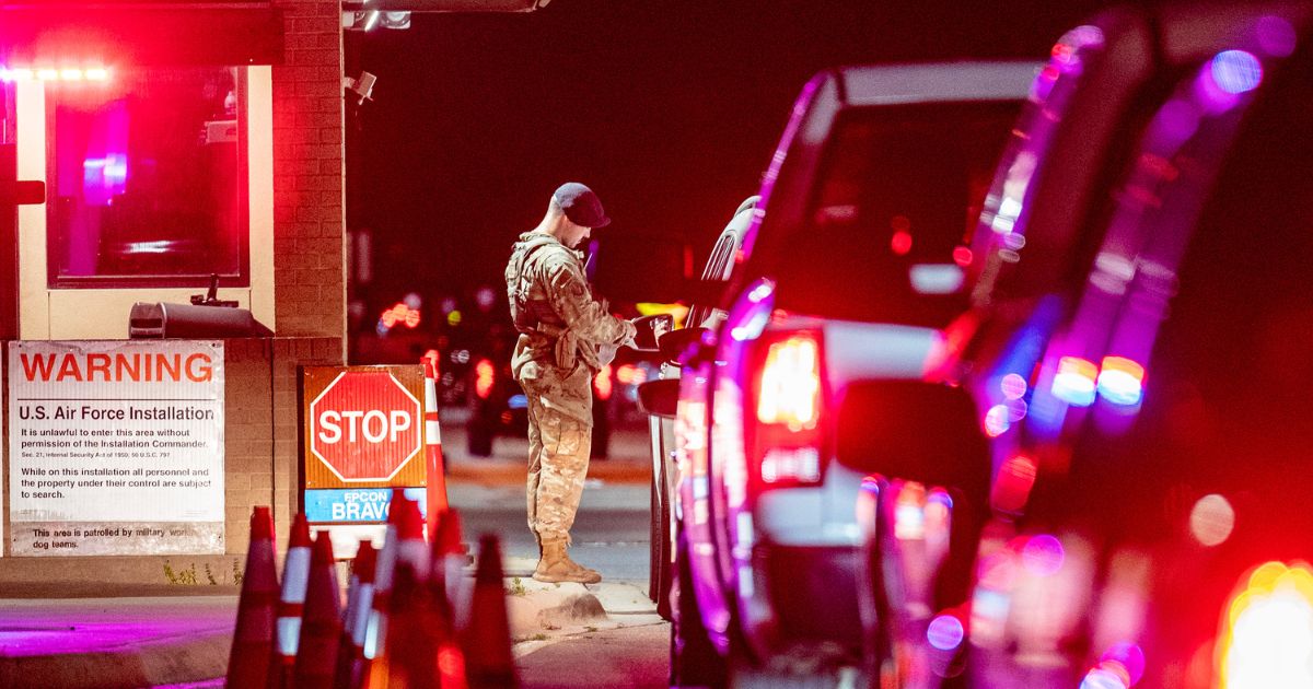 U.S. Air Force Senior Airman Jackson Morrow, 802nd Security Forces Squadron installation patrolman, verifies the authorization of a visitor’s base-access pass at Joint Base San Antonio-Lackland, Texas, June 26, 2024.