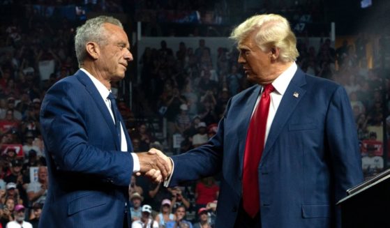 Former Republican presidential candidate Robert F. Kennedy Jr. and Republican presidential nominee, former U.S. President Donald Trump shake hands during a campaign rally.