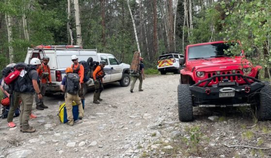 Search and rescue workers prepare to reach a stranded hiker.