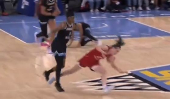 Caitlin Clark is knocked down during a WNBA game.