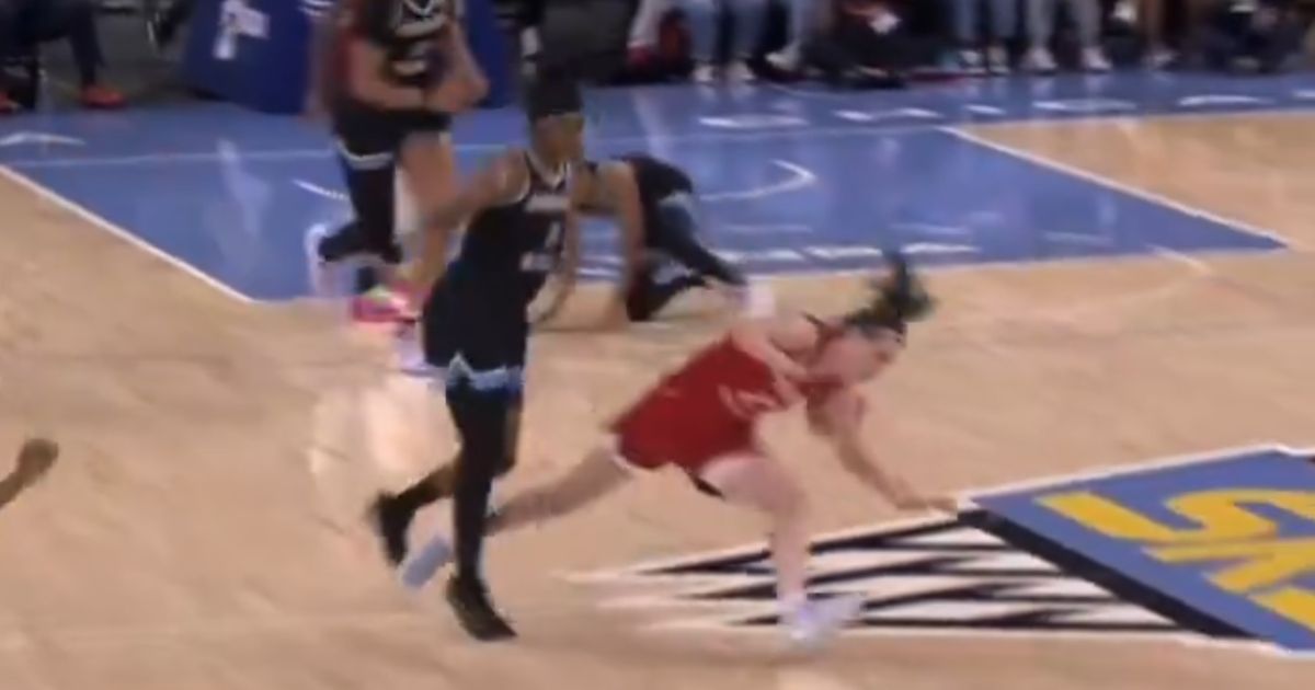 Caitlin Clark is knocked down during a WNBA game.