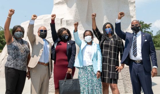 Texas Legislative Black Caucus members (L-R): Rhetta Andrews Bowers, Carl O. Sherman, Jasmine Crockett, Sheryl Cole, Shawn Thierry, and Ron Reynolds, pose for a photo at the Martin Luther King, Jr. Memorial on July 28, 2021 in Washington, DC.