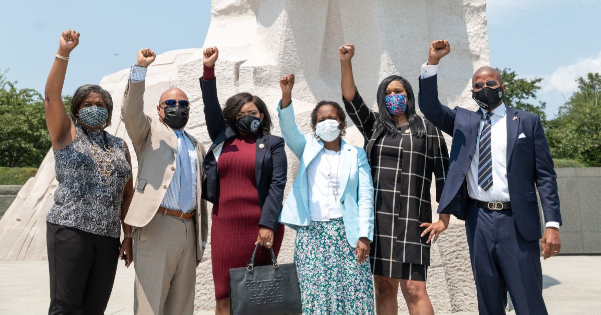 Texas Legislative Black Caucus members (L-R): Rhetta Andrews Bowers, Carl O. Sherman, Jasmine Crockett, Sheryl Cole, Shawn Thierry, and Ron Reynolds, pose for a photo at the Martin Luther King, Jr. Memorial on July 28, 2021 in Washington, DC.