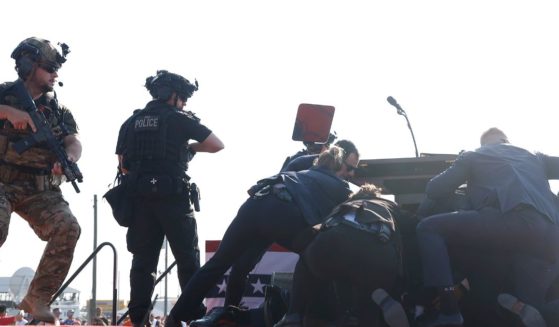 Republican presidential candidate former President Donald Trump is rushed offstage during a rally on July 13, 2024 in Butler, Pennsylvania.