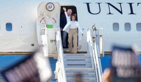 Democratic U.S. presidential candidate Vice President Kamala Harris and Democratic vice presidential candidate Minnesota Gov. Tim Walz walk off an aircraft after they landed at the Detroit Metropolitan Wayne County Airport.