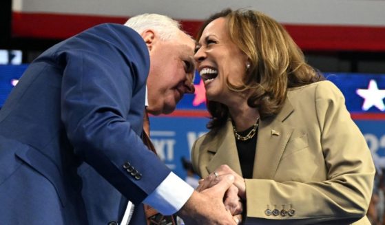 US Vice President and Democratic presidential candidate Kamala Harris (R) greets Minnesota Governor and Democratic vice presidential candidate Tim Walz during a campaign event.