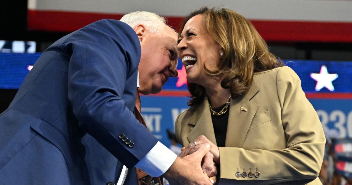 US Vice President and Democratic presidential candidate Kamala Harris (R) greets Minnesota Governor and Democratic vice presidential candidate Tim Walz during a campaign event.