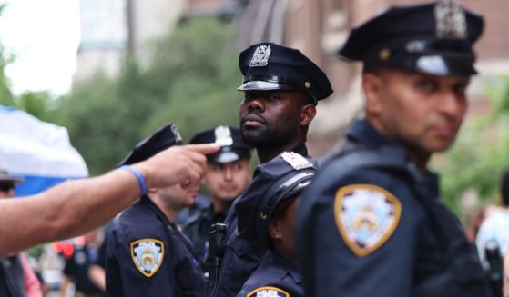 NYPD officers stand in between Pro-Israel protestors and Pro-Palestine protestors during a rally against the Baruch College Hillel campus organization at Baruch College on June 05, 2024 in New York City. Several arrests by NYPD were made during and after a counter protest by Pro-Israel protestors against Pro-Palestine protestors who were demonstrating against the Baruch College Hillel campus organization's support of the Israel Defense Forces during the conflict with Hamas. The war has resulted in the deaths of over 35,000 Palestinians, mostly civilians, and has displaced 2.3 million people from their homes. The conflict was sparked by an attack from Hamas on October 7th.