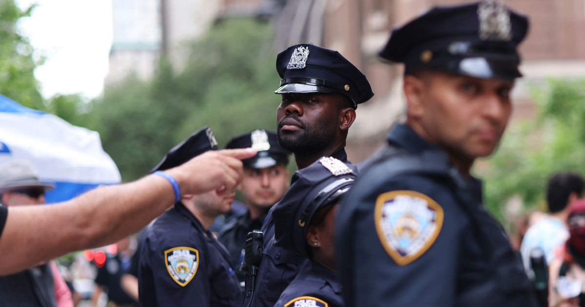 NYPD officers stand in between Pro-Israel protestors and Pro-Palestine protestors during a rally against the Baruch College Hillel campus organization at Baruch College on June 05, 2024 in New York City. Several arrests by NYPD were made during and after a counter protest by Pro-Israel protestors against Pro-Palestine protestors who were demonstrating against the Baruch College Hillel campus organization's support of the Israel Defense Forces during the conflict with Hamas. The war has resulted in the deaths of over 35,000 Palestinians, mostly civilians, and has displaced 2.3 million people from their homes. The conflict was sparked by an attack from Hamas on October 7th.