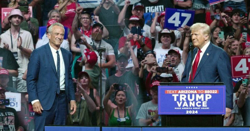 Former President Donald Trump, right, welcomes onstage former independent presidential candidate Robert F. Kennedy Jr.,left, during a campaign rally in Glendale, Arizona, on Aug. 23.