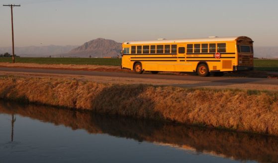 A school bus passes along a farm canal near El Centro, California, on March 12, 2009.