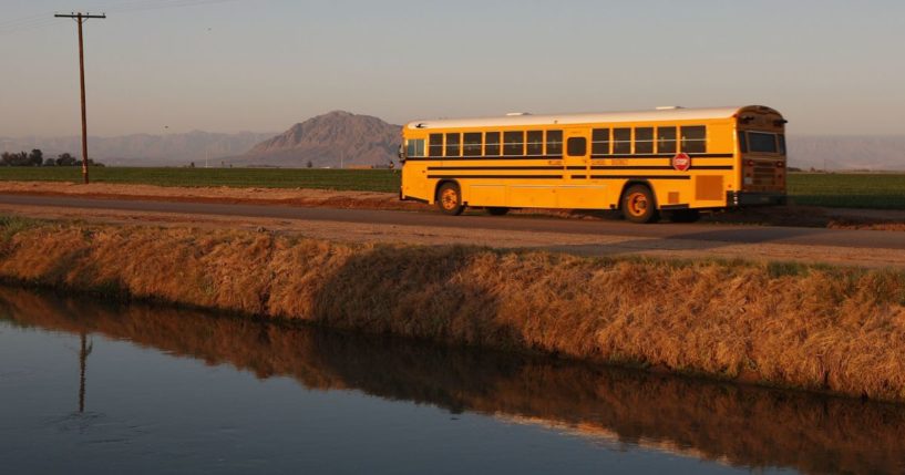 A school bus passes along a farm canal near El Centro, California, on March 12, 2009.