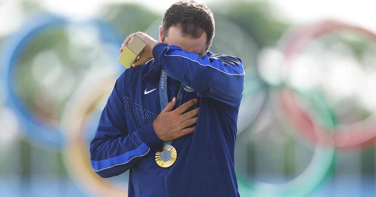 Gold medalist Scottie Scheffler of Team United States reacts on the podium during the Men's Individual Stroke Play medal ceremony at the Summer Olympics in Paris, France, on Sunday.