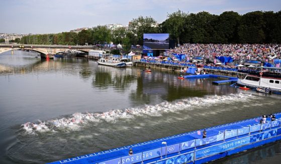 Athletes swim in the Seine during the men's individual triathlon race at the Paris 2024 Olympic Games on Wednesday.