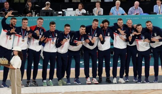 The Serbian men's basketball team stands on the podium after receiving their bronze medals at the Paris Olympics on Aug. 10.