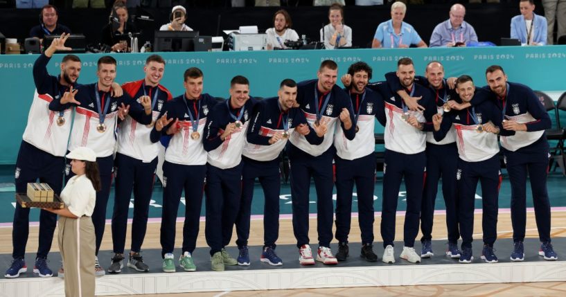 The Serbian men's basketball team stands on the podium after receiving their bronze medals at the Paris Olympics on Aug. 10.