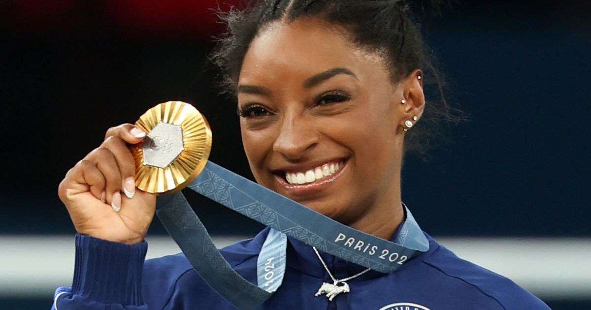 U.S. gymnast Simone Biles holds up the gold Medal after the women's Artistic Gymnastics All-Around Final at the Paris Olympics in Paris, France, on Thursday.