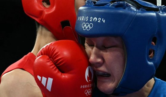 Uzbekistan's Sitora Turdibekova, right, is hit by Taiwan's Lin Yu-ting, left, during the women's 57kg preliminaries round of 16 boxing match during the Paris 2024 Olympic Games in Villepinte, France, on Friday.