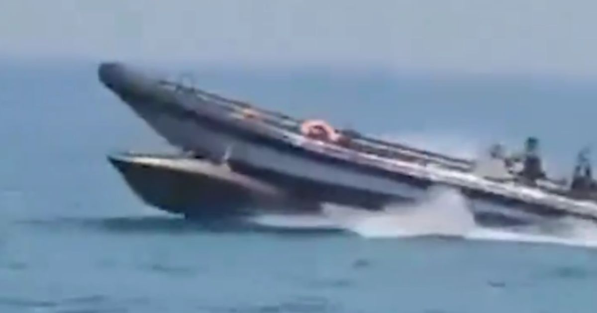 Video posted to X on Wednesday shows a boat from Spain's Guardia Civil, top, attempting to stop a boat of illegal immigrants, bottom, by cutting the vessel in half.