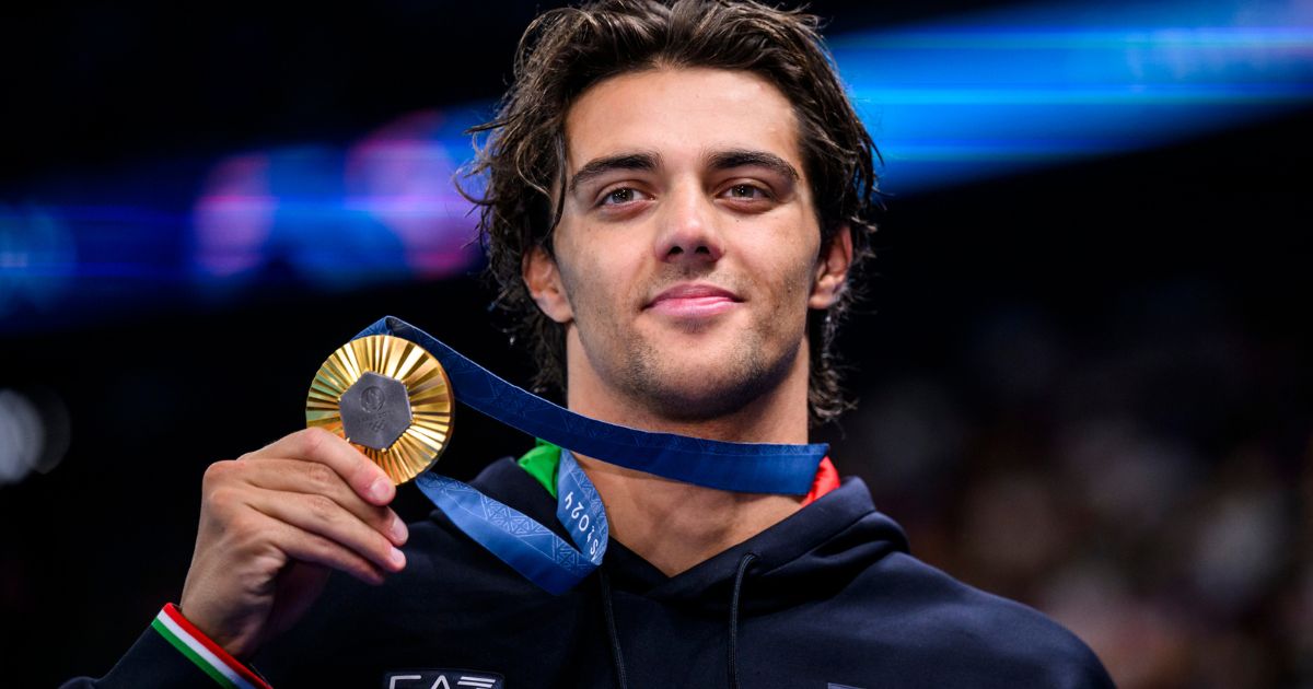 Gold Medalist Thomas Ceccon from Italy celebrates after the Medal Ceremony for the Men's 100-meter Backstroke Final in the 2024 Paris Olympics in Paris, France, on July 29.