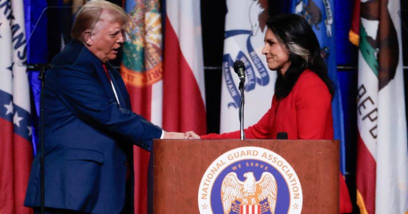 Former President Donald Trump shakes hands with former Rep.Tulsi Gabbard after she endorsed him at the National Guard Association conference in Detroit, Michigan, on Monday.