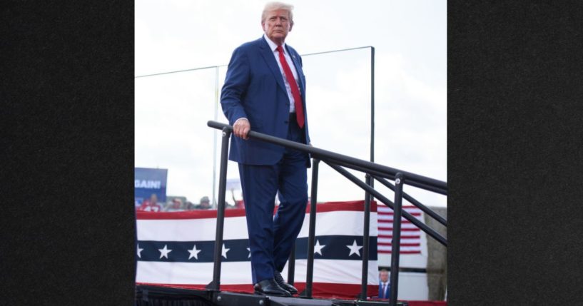 Former president Donald Trump leaves a stage after offering remarks to a crowd during an event Wednesday in Asheboro, North Carolina. Earlier, Trump had walked out from behind bulletproof glass panels to check on a woman who was apparently overcome by the sun.