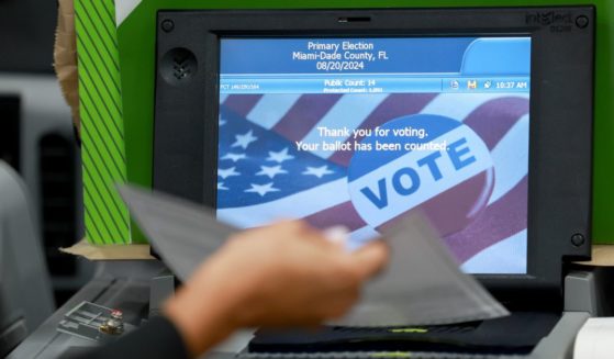 A Miami-Dade election worker checks voting machines for accuracy at the Miami-Dade Election Department headquarters in Doral, Florida, on July 31.