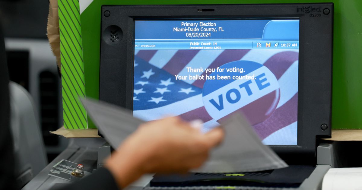 A Miami-Dade election worker checks voting machines for accuracy at the Miami-Dade Election Department headquarters in Doral, Florida, on July 31.