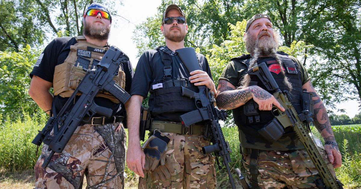 Members of the Michigan Liberty Militia pose for a photo at a "Defend Our 2A: Michigan's Fight for Self Preservation" rally at a farm on July 19, 2023 in Ionia, Michigan. The rally was moved this year from the Michigan State Capitol where it was previously held. Key speakers at the rally are Kyle Rittenhouse, the then-17-year-old who shot and killed two protestors in Kenosha, Wisconsin, claimed self-defense, and was found not guilty, former Arizona Sheriff Richard Mack, and Mark and Patricia McCloskey.