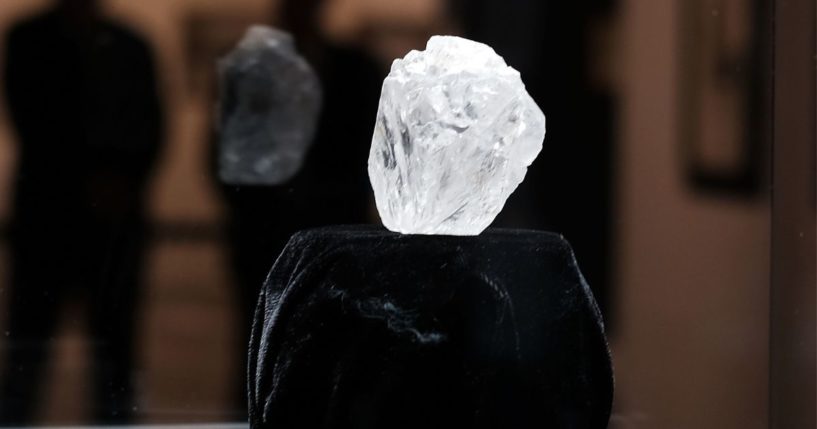 Guards stand next to the 1109-carat rough Lesedi La Rona diamond, the biggest rough diamond discovered in more than a century, at Sotheby's on May 04, 2016 in New York City. The stone was found by Lucara Diamond Corp. last year at its Karowe mine in Botswana. The diamond, which is nearly the size of a tennis ball at 66.4 x 55 x 42 mm and is believed to be about 2.5 billion to 3 billion years old, was named "Our Light" in the local Tswana language. Lesedi La Rona will be offered at auction in London on June 29 and be on display at Sotheby's New York. The diamond could sell for $70 million or more.