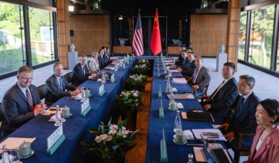 China's Foreign Minister Wang Yi (4th R) and US National Security Advisor Jake Sullivan (3rd L) pose for photos before talks at Yanqi Lake in Beijing on August 27, 2024.