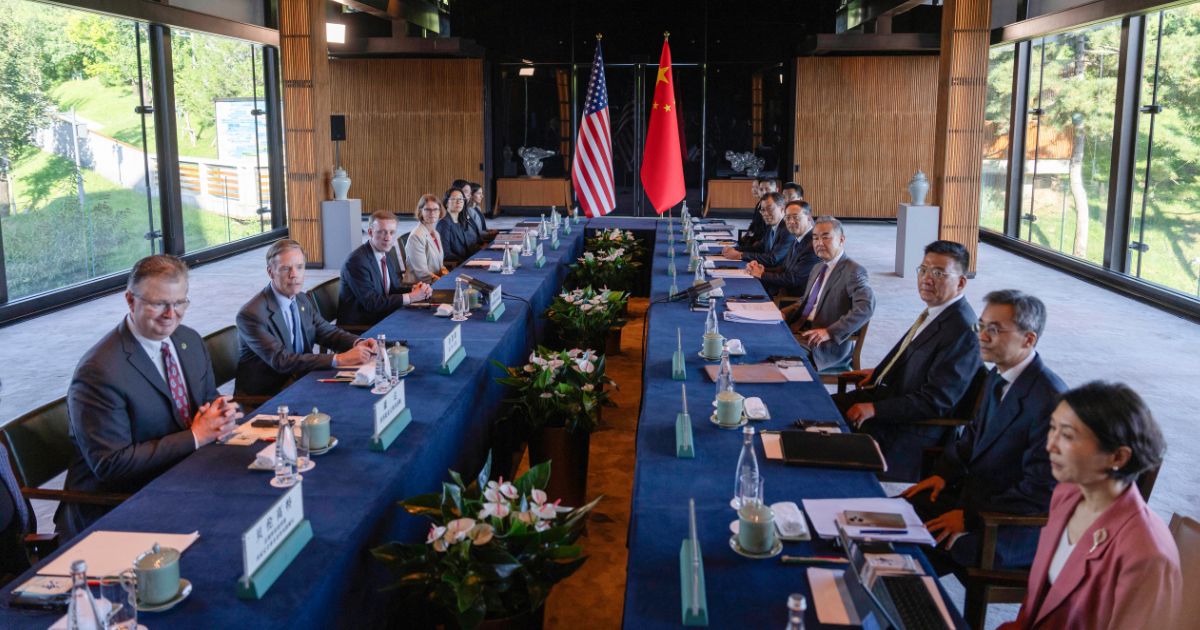 China's Foreign Minister Wang Yi (4th R) and US National Security Advisor Jake Sullivan (3rd L) pose for photos before talks at Yanqi Lake in Beijing on August 27, 2024.