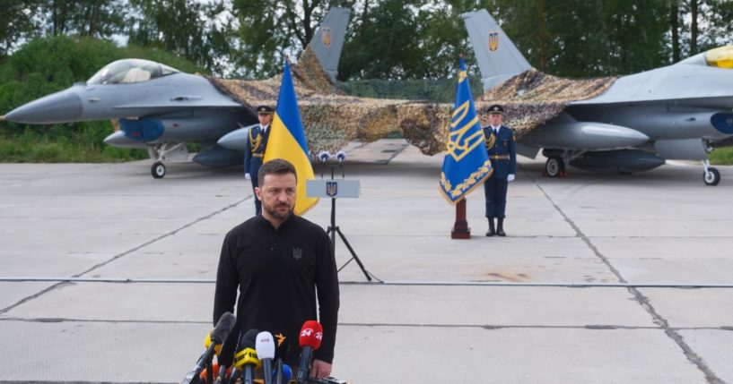 Ukrainian President Volodymyr Zelenskyy stands in front of the first General Dynamics F-16 Fighting Falcons received by Ukraine as he congratulates Ukrainian military on the Day of Ukrainian Air Force on Aug. 4.