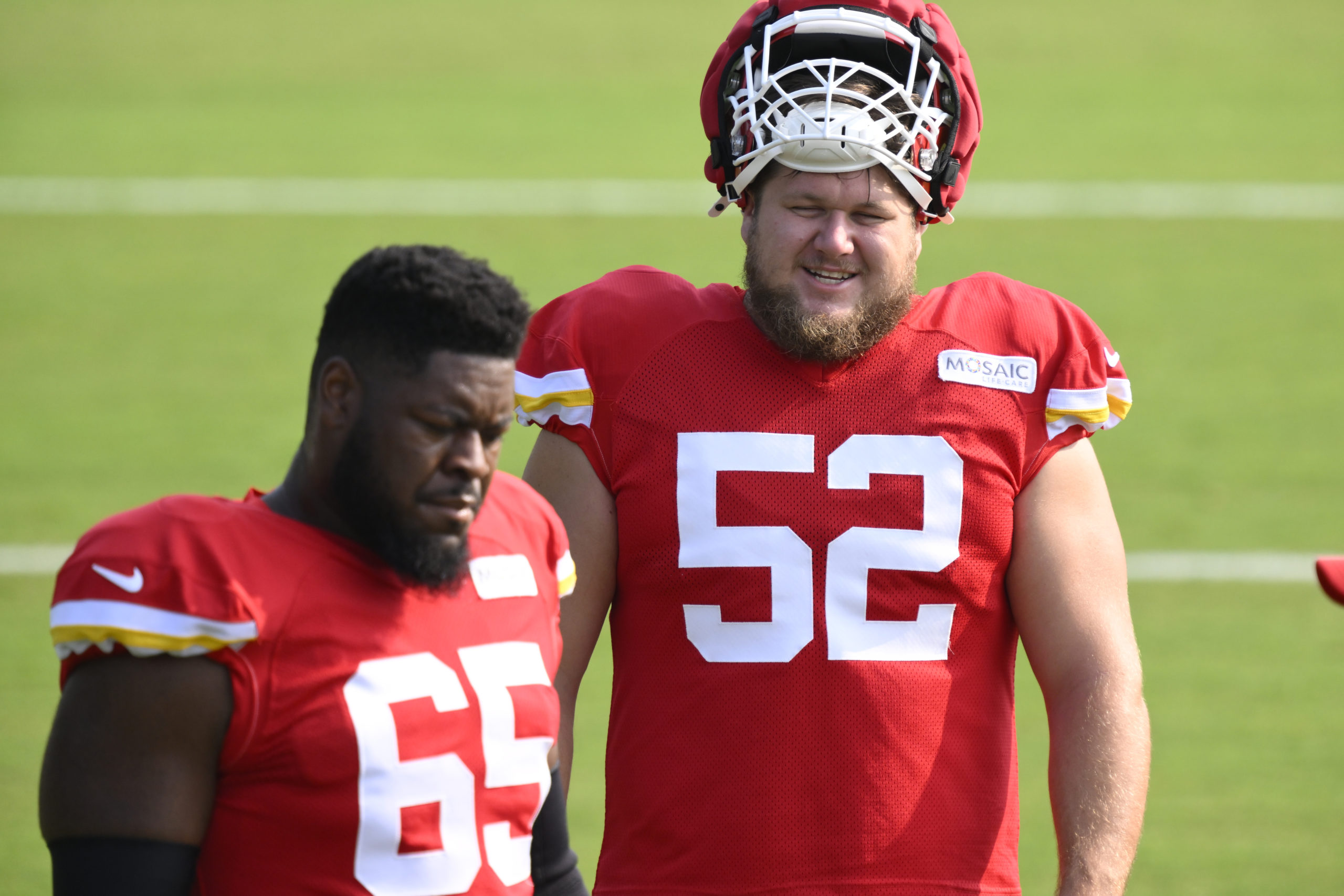 Kansas City Chiefs center Creed Humphrey (52) talks to Chiefs guard Trey Smith (65) during NFL football training camp Friday, July 26, 2024, in St. Joseph, Missouri.