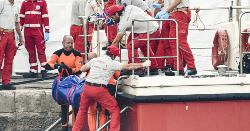 Italian firefighter divers bring ashore in a plastic bag the body of one of the victims of a shipwreck, in Porticello, Sicily, southern Italy on Thursday. Divers searching the wreck of the superyacht Bayesian that sank off Sicily on Monday recovered a fifth body on Thursday and continued to search for one more as investigators sought to learn why the vessel sank so quickly.