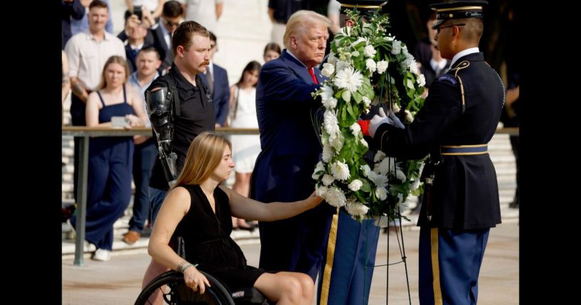 Republican presidential nominee, former U.S. President Donald Trump lays a wreath alongside Marine Cpl. Kelsee Lainhart (Ret.) and and U.S. Marine Corps. Sergeant Tyler Vargas-Andrews (Ret.) who were injured at the Abbey Gate Bombing, during a wreath-laying ceremony at the Tomb of the Unknown Soldier at Arlington National Cemetery on August 26, 2024 in Arlington, Virginia.