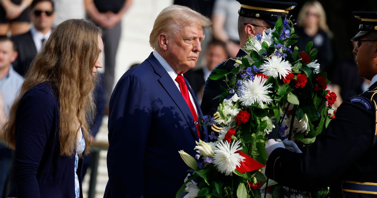 Republican presidential nominee, former U.S. President Donald Trump stands alongside Misty Fuoco, whose sister Sgt. Nicole Gee died in Abbey Gate Bombing, at a wreath laying ceremony at the Tomb of the Unknown Soldier at Arlington National Cemetery on August 26, 2024 in Arlington, Virginia.