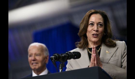 US Vice President and Democratic presidential candidate Kamala Harris speaks as President Joe Biden looks on at Prince George's Community College in Largo, Maryland, on August 15, 2024.