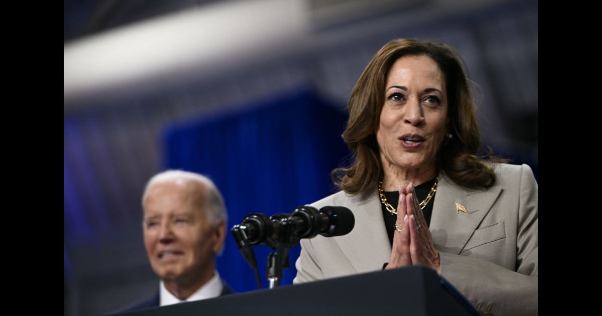 US Vice President and Democratic presidential candidate Kamala Harris speaks as President Joe Biden looks on at Prince George's Community College in Largo, Maryland, on August 15, 2024.