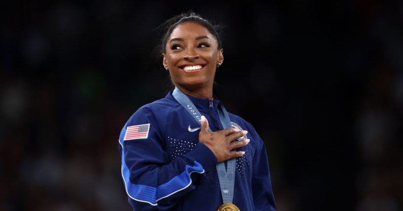 Gold medalist Simone Biles of Team United States celebrates on the podium during the medal ceremony for the Artistic Gymnastics Women's Vault Final on day eight of the Olympic Games Paris 2024 at Bercy Arena on August 3, 2024 in Paris, France.