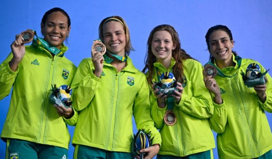 Brazil women's swimming team (L to R) Celine Souza Bispo, Giovanna Tomanik Diamante, Stephanie Balduccini and Ana Carolina Vieira, celebrate after winning the bronze medal during the women's 4X100m freestyle relay final swimming event of the Pan American Games Santiago 2023, at the Aquatics Centre in the National Stadium Sports Park in Santiago, on October 21, 2023.