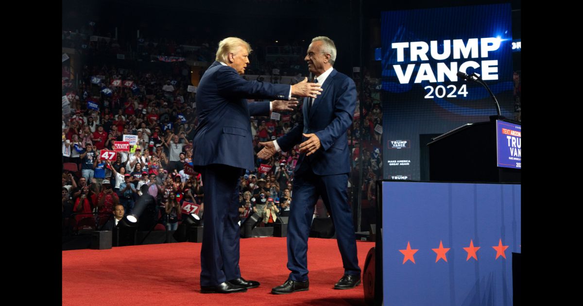 Republican presidential nominee, former U.S. President Donald Trump (L) embraces former presidential candidate Robert F. Kennedy Jr. during a campaign rally at Desert Diamond Arena on August 23, 2024 in Glendale, Arizona.