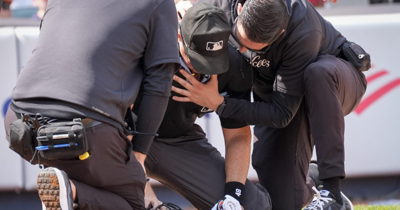 Medical staff tend to umpire Nick Mahrley, center, after he was hit by a bat during the fifth inning of a baseball game between the Colorado Rockies and the New York Yankees in New York on Sunday.